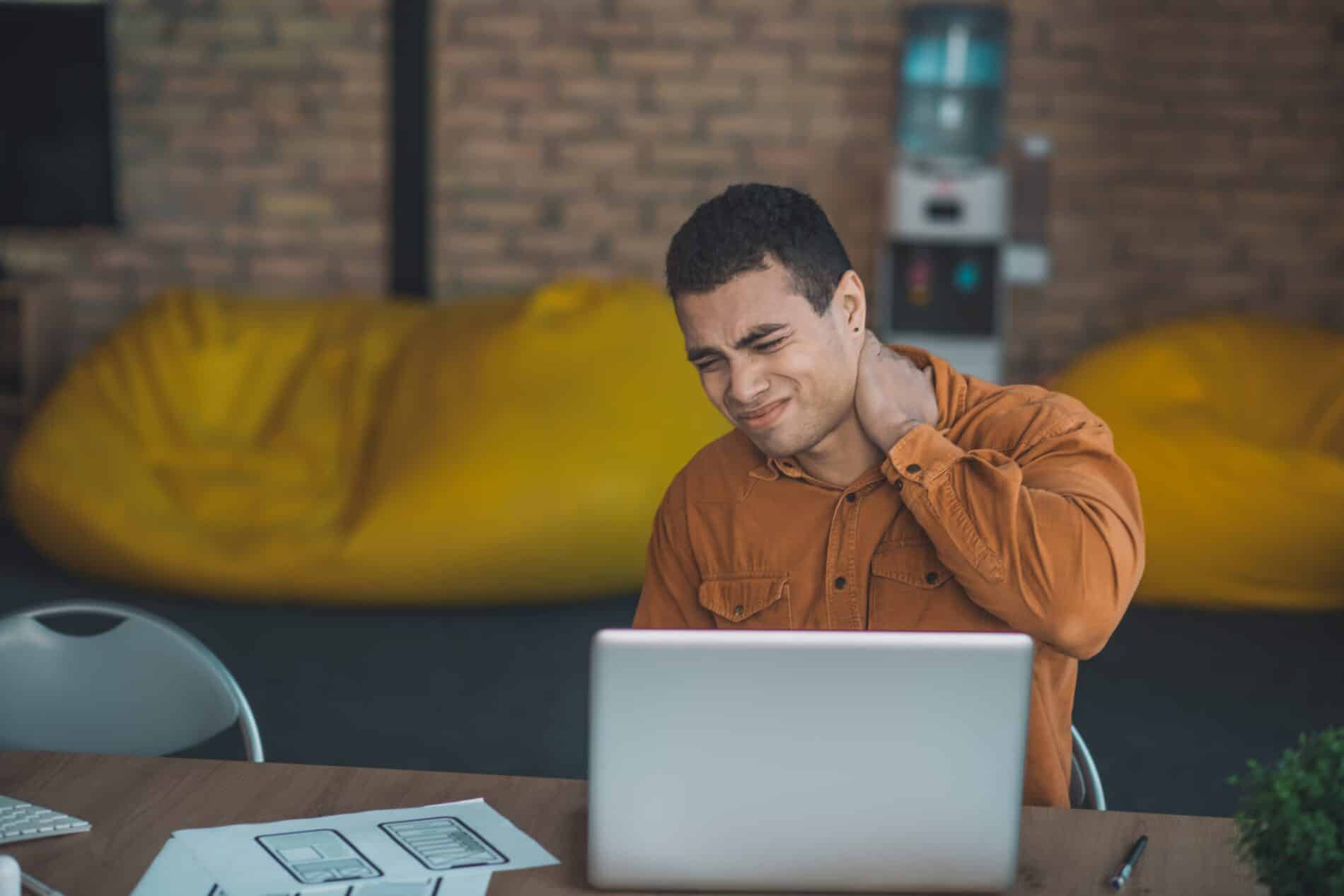 nice brunette man putting his hand on the neck 2023 11 27 05 29 05 utc scaled Tips for Fatigue and Forward Head Posture- Innovative Health