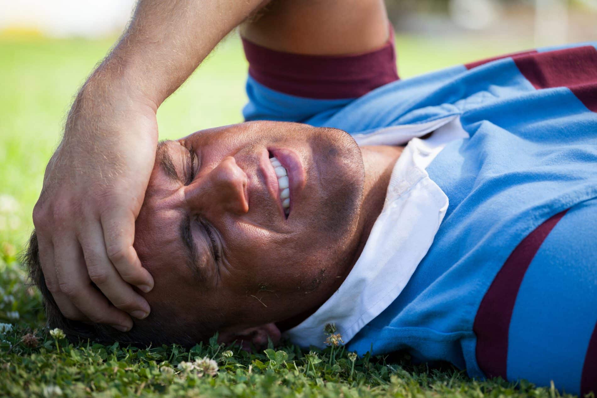 injured rugby player with eyes closed lying on fie 2023 11 27 05 26 50 utc scaled What Are The Signs of Concussions | Innovative Health
