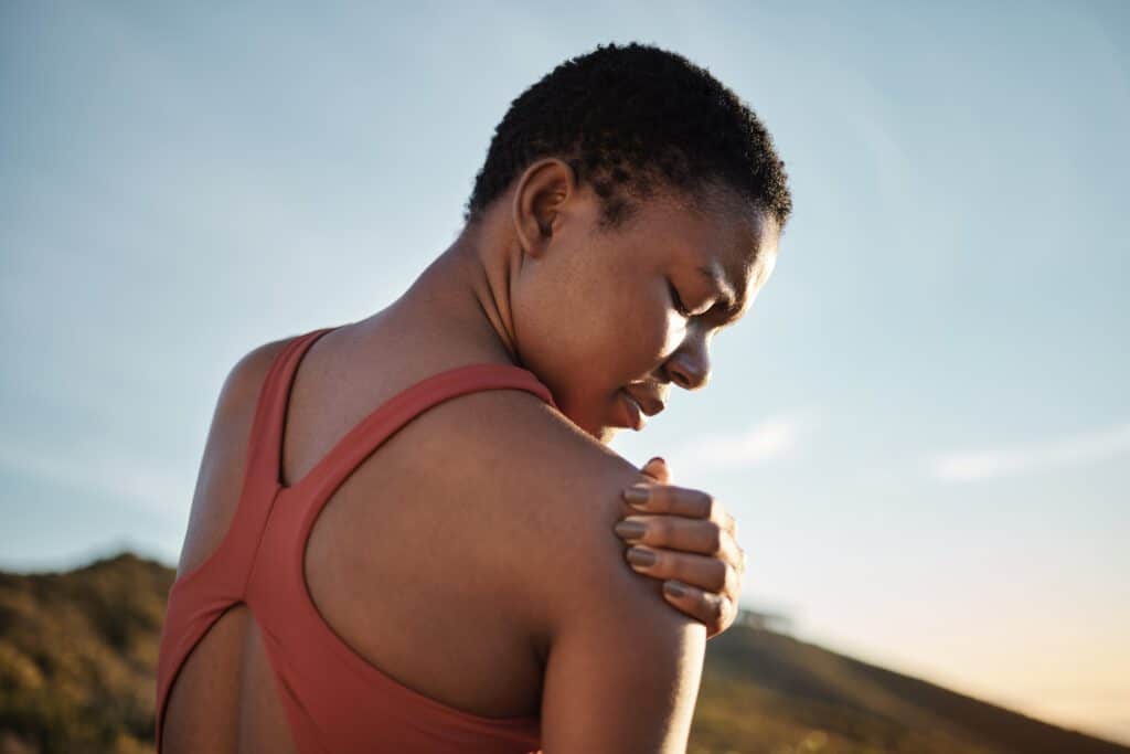 Athlete holding an injured shoulder after activity