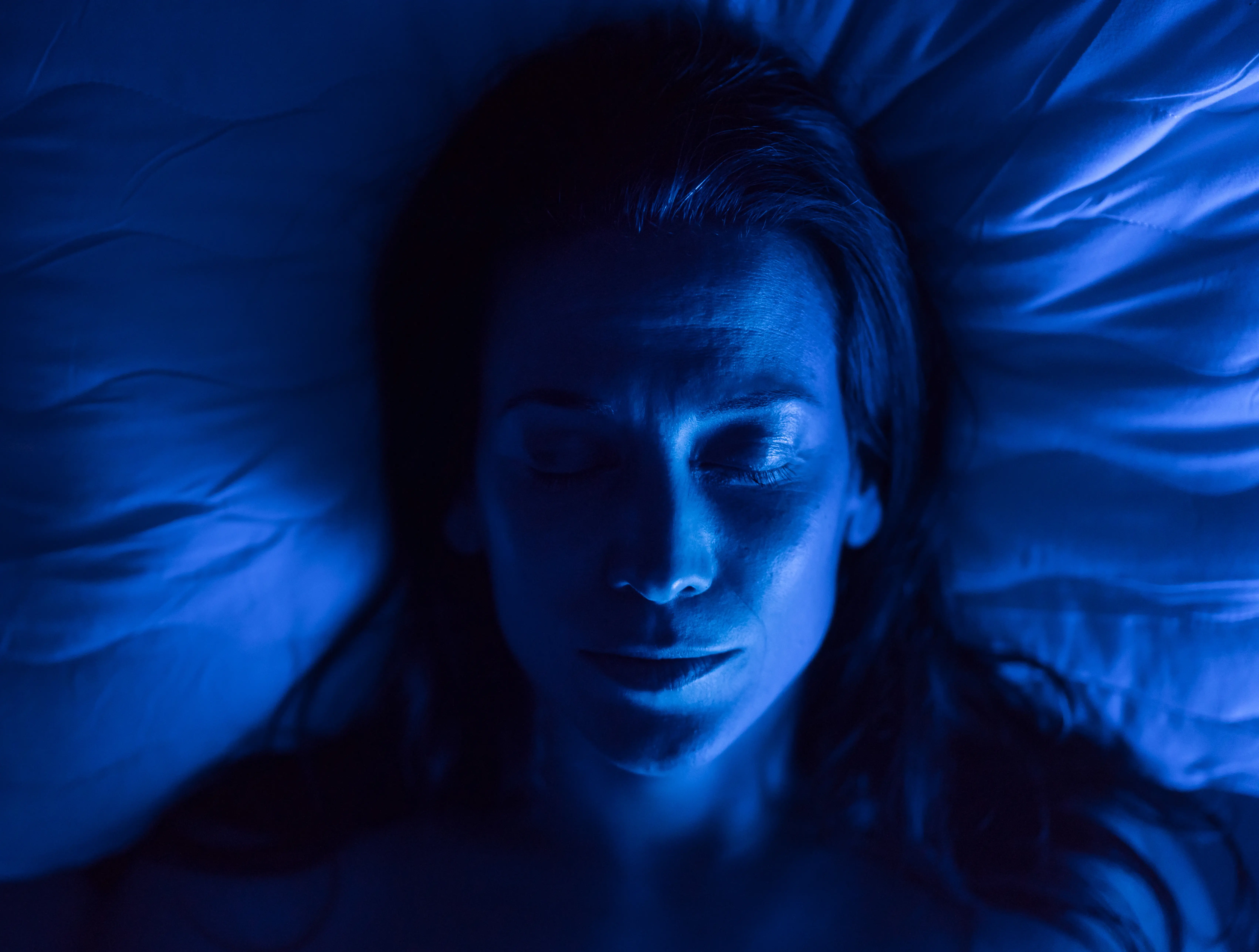 woman sleeping in a blue light