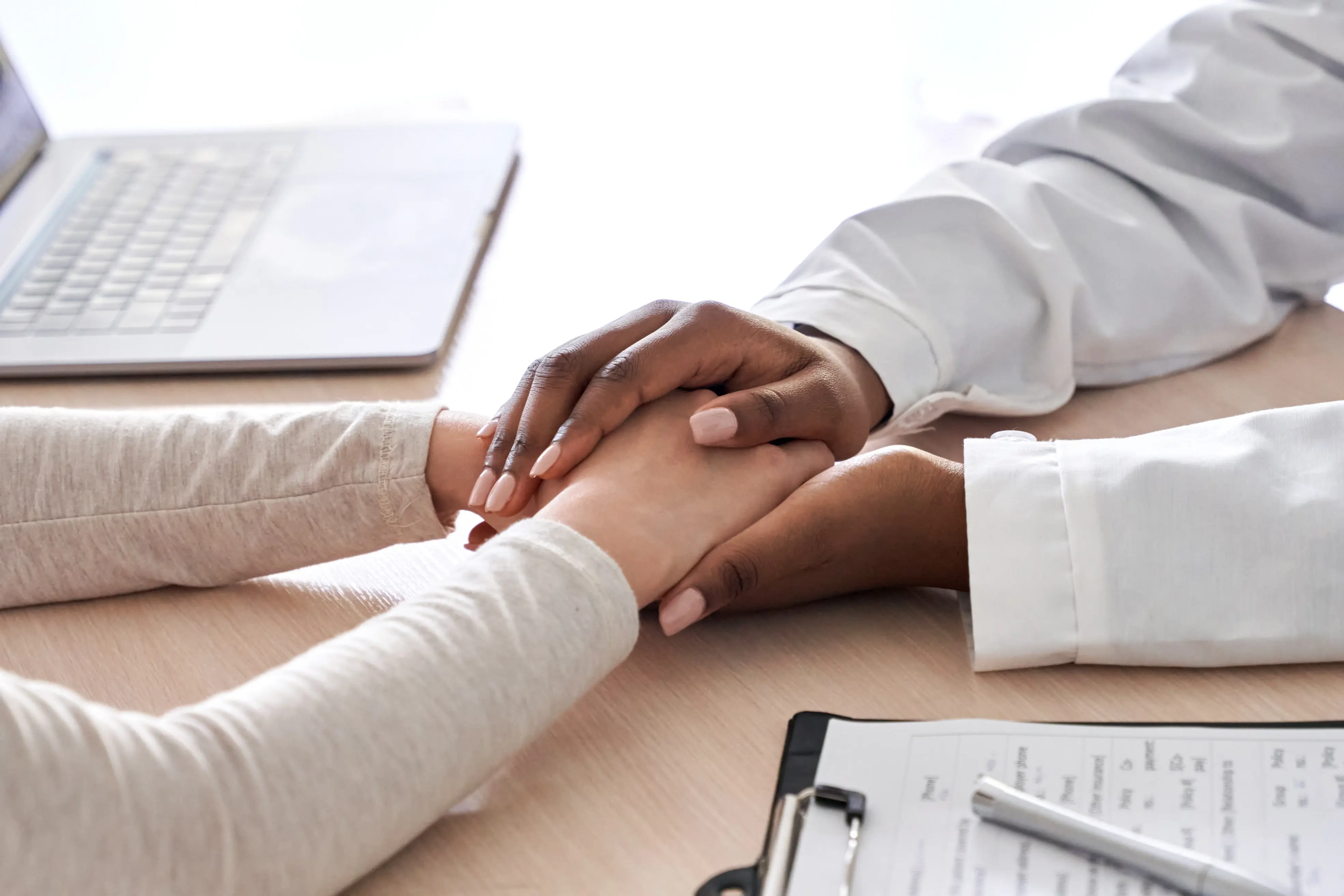Two person touching hands for healing
