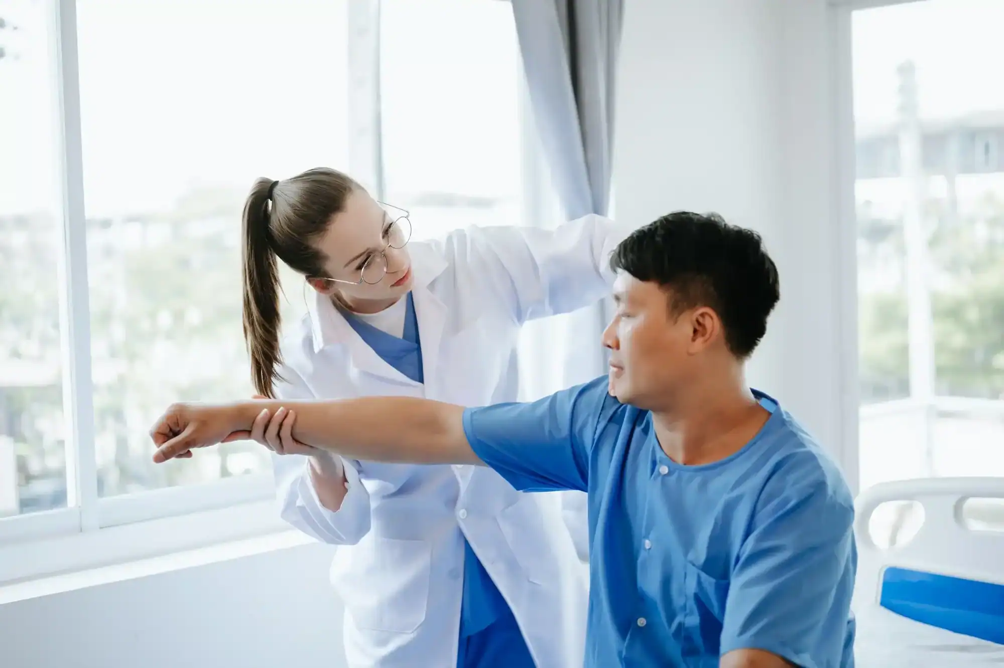 Clinician supporting a patient during functional neurological therapy